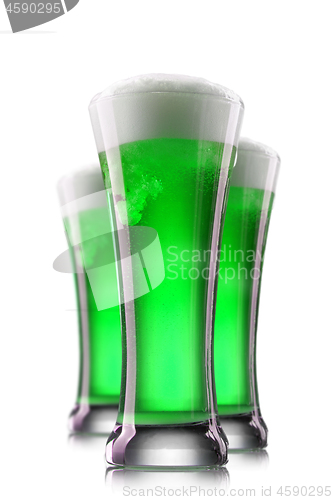 Image of Green beer in glasses isolated on a white background.