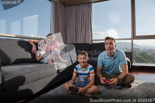 Image of Happy family playing a video game