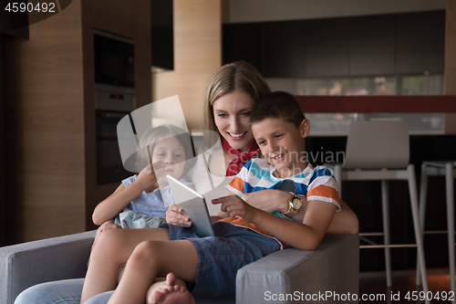 Image of happy young mother spending time with kids