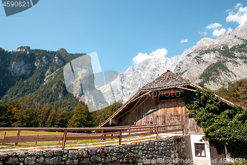 Image of Beautiful view of traditional wooden boat house at the shores of famous Lake Obersee in scenic Nationalpark Berchtesgadener Land