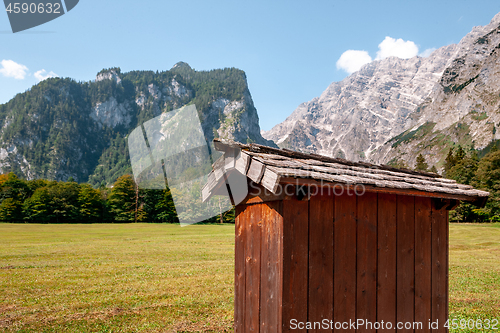 Image of Beautiful view of traditional wooden boat house at the shores of famous Lake Obersee in scenic Nationalpark Berchtesgadener Land