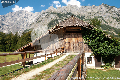 Image of Beautiful view of traditional wooden boat house at the shores of famous Lake Obersee in scenic Nationalpark Berchtesgadener Land