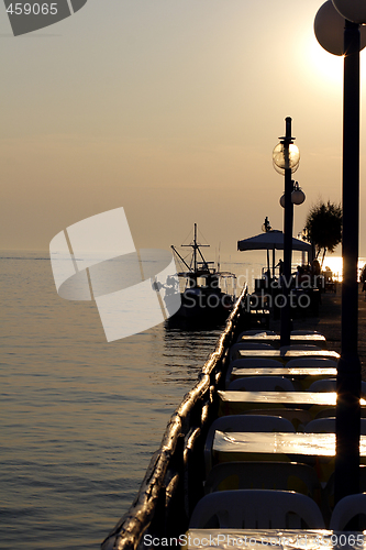 Image of sunset over fishing village in greece