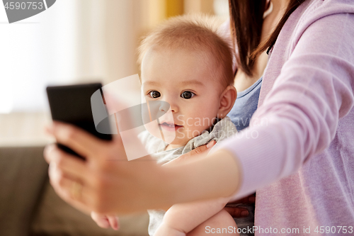 Image of close up of mother with baby taking selfie