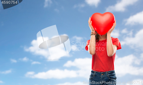 Image of teenage girl with red heart shaped balloon