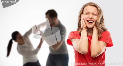 Image of girl covering ears over her parents having fight