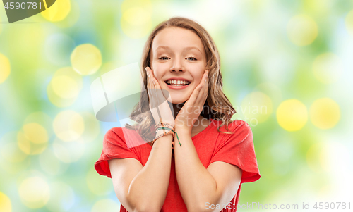 Image of smiling teenage girl over green lights