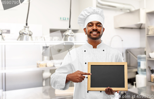 Image of indian chef with chalkboard at restaurant kitchen