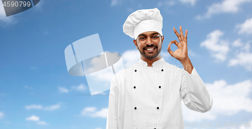 Image of happy male indian chef in toque showing ok gesture