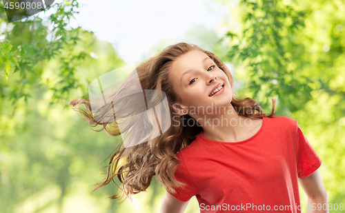 Image of smiling teenage girl over natural background