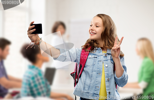 Image of teenage student girl taking selfie by smartphone