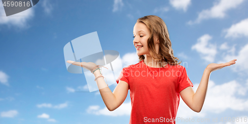 Image of smiling teenage girl holding empty hand