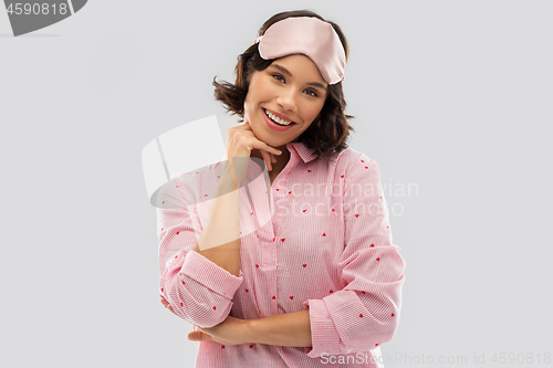 Image of happy young woman in pajama and eye sleeping mask