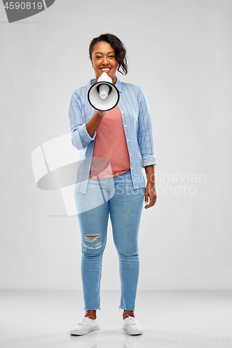 Image of happy african american woman over grey background