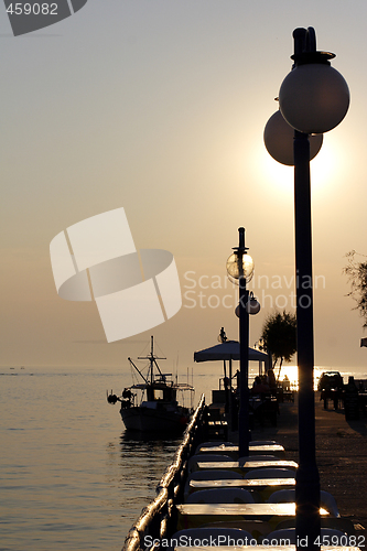 Image of sunset over fishing village in greece