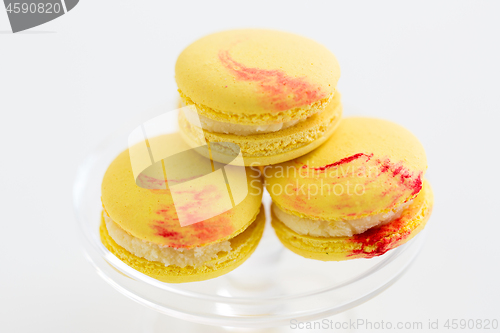 Image of close up of yellow macarons on confectionery stand