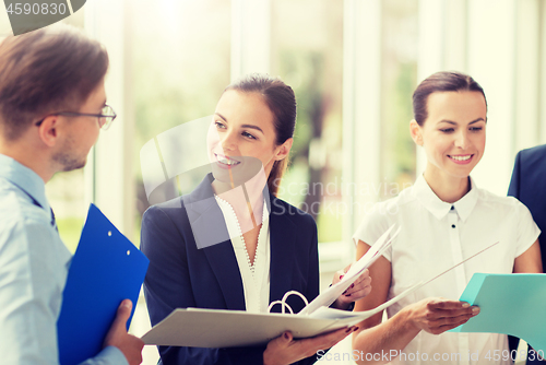 Image of business team with folders meeting at office