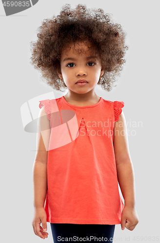 Image of sad little african american girl over grey