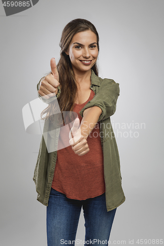 Image of Confident woman with thumbs up