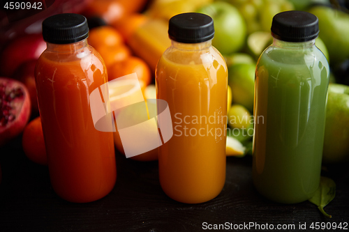 Image of Colorful bottles filled with fresh fruit and vegetable juice or smoothie