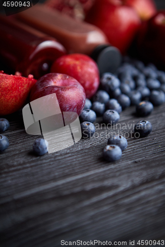 Image of Mix of fresh red and black fruits. With botteled fresh juices