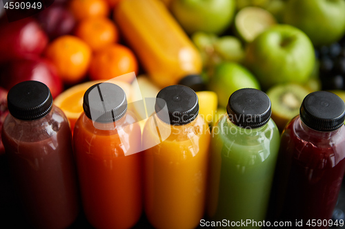 Image of Colorful bottles filled with fresh fruit and vegetable juice or smoothie