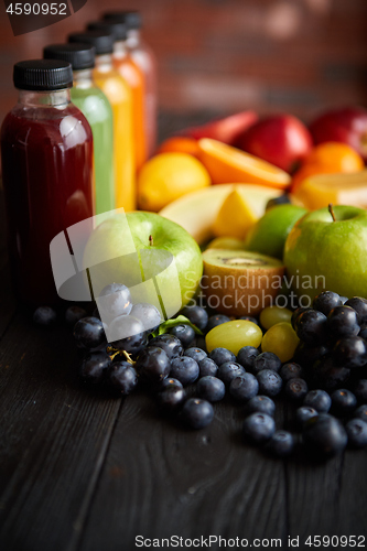 Image of Colorful bottles filled with fresh fruit and vegetable juice or smoothie