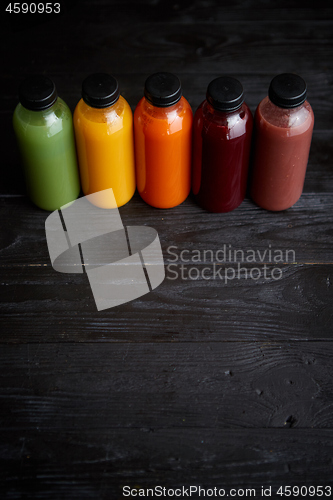 Image of Colorful bottles filled with fresh fruit and vegetable juice or smoothie