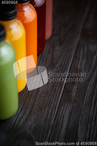 Image of Colorful bottles filled with fresh fruit and vegetable juice or 