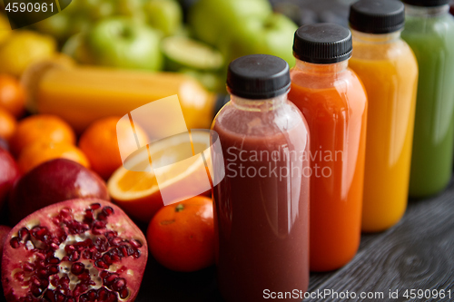 Image of Colorful bottles filled with fresh fruit and vegetable juice or smoothie