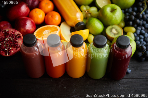 Image of Colorful bottles filled with fresh fruit and vegetable juice or smoothie