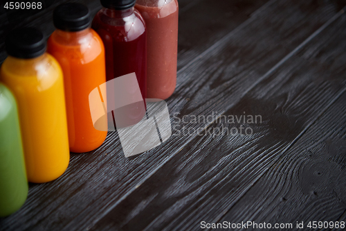 Image of Colorful bottles filled with fresh fruit and vegetable juice or 