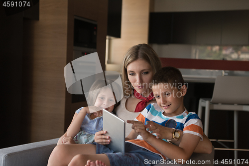 Image of happy young mother spending time with kids