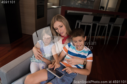 Image of happy young mother spending time with kids