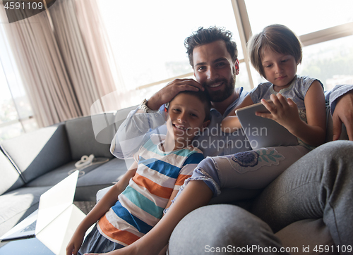 Image of happy young father spending time with kids