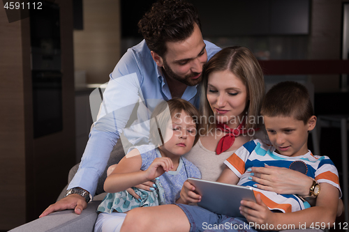 Image of happy young couple spending time with kids