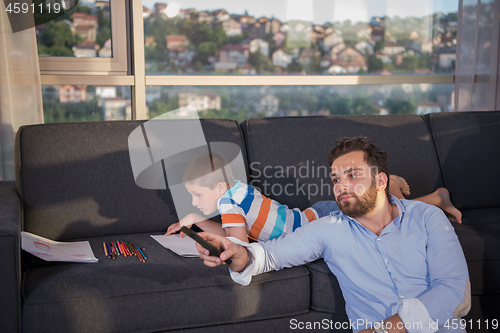 Image of Happy Young Family Playing Together on sofa