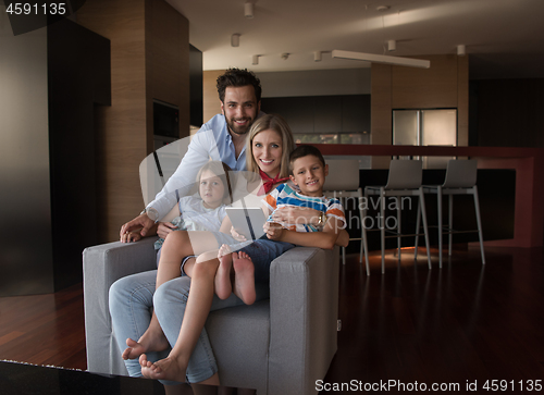 Image of happy young couple spending time with kids