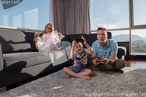 Image of Happy family playing a video game