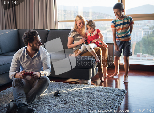 Image of Happy family playing a video game