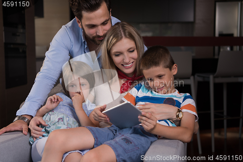 Image of happy young couple spending time with kids