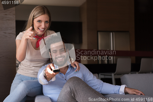 Image of Young couple on the sofa watching television