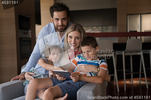 Image of happy young couple spending time with kids