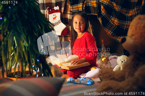 Image of happy girl reading a book in the winter