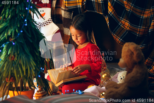 Image of happy girl reading a book in the winter