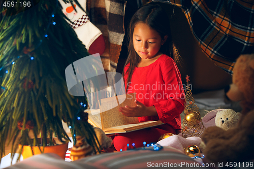 Image of happy girl reading a book in the winter