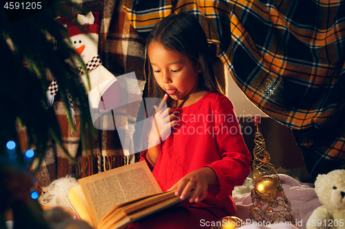 Image of happy girl reading a book in the winter