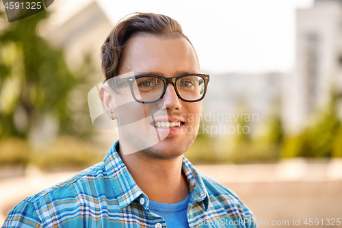 Image of portrait of man in glasses outdoors in summer