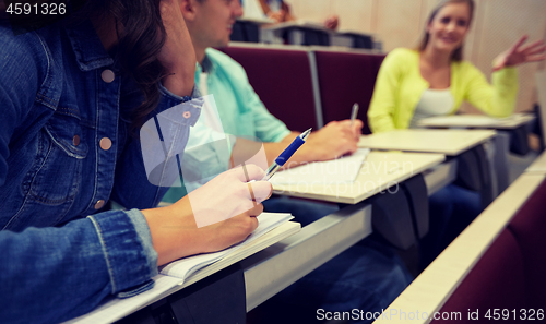 Image of group of students with notebooks at lecture hall