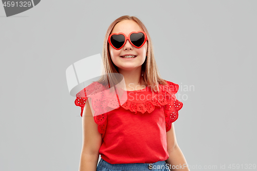 Image of smiling preteen girl with heart shaped sunglasses